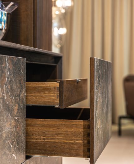 Open drawers of a modern dresser featuring stone texture and wooden frame. Stylish minimalist design.